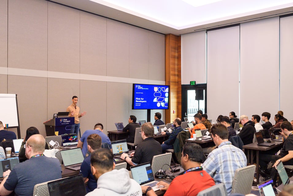 Trainer Daniel Ciocirlan leads a full training room.