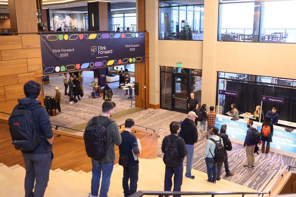 Flink Forward registration desk opens with a line of excited attendees.